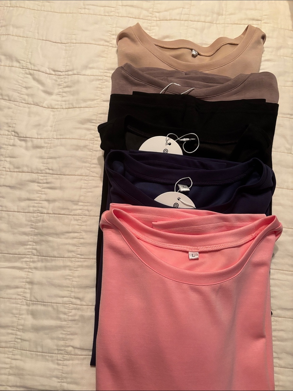 Stack of Women's Crew Neck Tops in Pink, Navy, Black, Taupe, Beige
